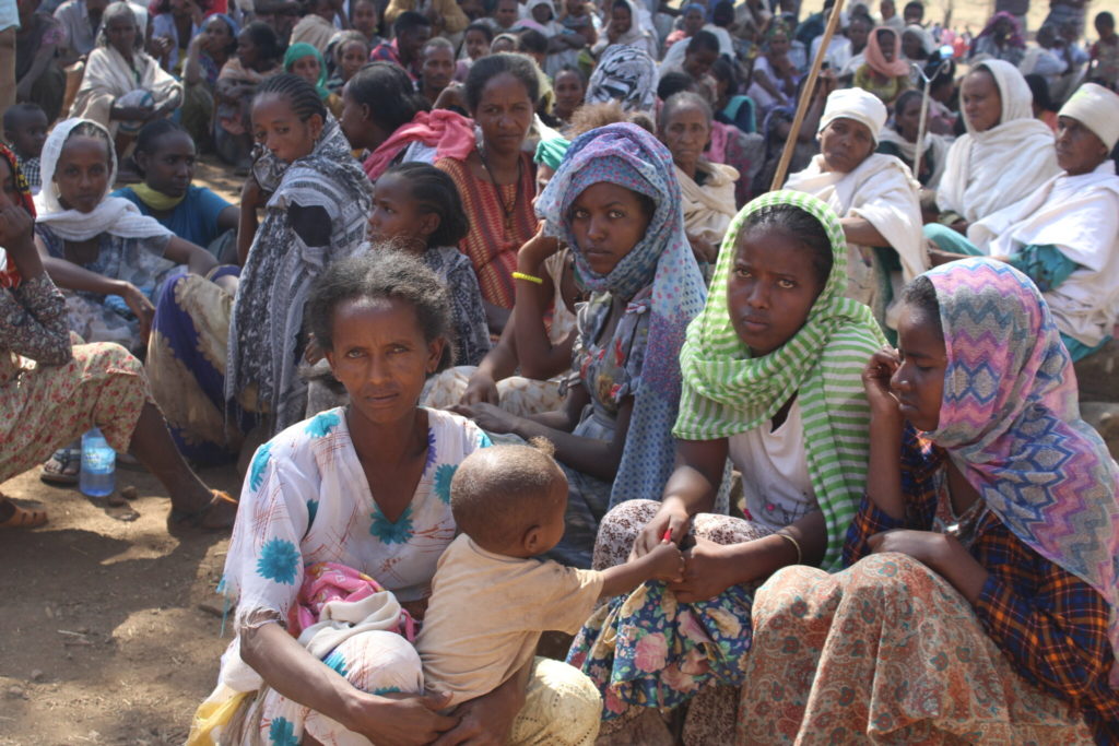 Refugee women and children in Tigray, Ethiopia gather to wait for humanitarian aid.